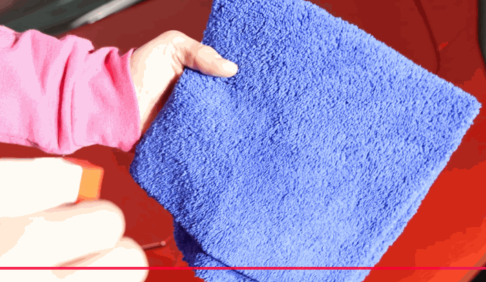 spraying a microfiber cloth